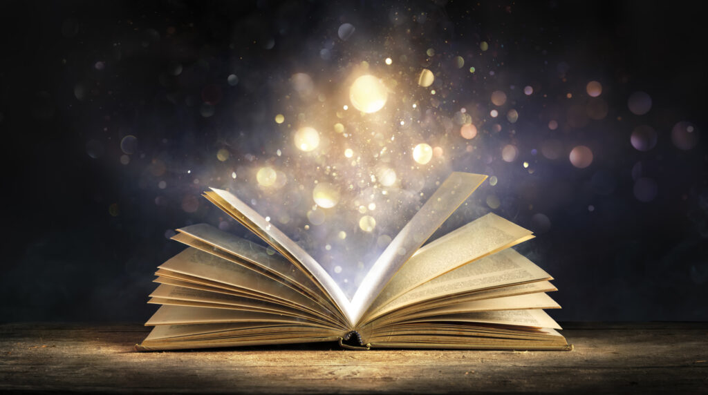 Magic Book With Lights Glowing In Black Background